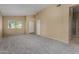 Spacious living room with neutral carpet, bright natural light and white trim at 13861 W Elm St, Surprise, AZ 85374