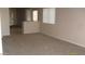View of empty living room featuring neutral walls, plush carpet, and sunlit windows, perfect for relaxation at 13861 W Elm St, Surprise, AZ 85374