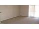 An empty living room showcasing neutral walls and plush carpeting at 13861 W Elm St, Surprise, AZ 85374