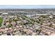 An aerial view shows the neighborhood with many houses, a street, trees, and shops nearby at 16538 N Oachs Dr, Surprise, AZ 85374