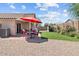 Inviting backyard featuring gravel, artificial turf, patio and outdoor seating at 16538 N Oachs Dr, Surprise, AZ 85374