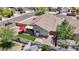 View of the home's backyard that has a grassy patch, patio set, hot tub, and string lights at 16538 N Oachs Dr, Surprise, AZ 85374