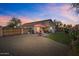 A spacious backyard featuring an extended patio, gravel landscaping, and a grassy area at 16538 N Oachs Dr, Surprise, AZ 85374