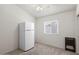 Minimalist bedroom featuring a large window, a neutral color palette, and a refrigerator at 16538 N Oachs Dr, Surprise, AZ 85374