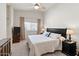 Comfortable bedroom with a plush bed, dark wood furniture, and a ceiling fan at 16538 N Oachs Dr, Surprise, AZ 85374