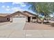 Well-maintained single-story home with a two-car garage, desert landscaping, and an inviting entrance at 16538 N Oachs Dr, Surprise, AZ 85374