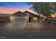 Charming single-story home with a two-car garage, desert landscaping, and a warm, inviting facade at 16538 N Oachs Dr, Surprise, AZ 85374