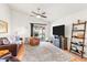 Bright living room with a ceiling fan, access to the backyard, and stylish shelving at 16538 N Oachs Dr, Surprise, AZ 85374