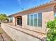 Backyard patio features brick pavers, covered area, and views of the lush landscaping at 16881 W Merrell St, Goodyear, AZ 85395