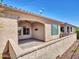 Backyard patio with brick pavers, covered area, and views of the lush landscaping and blue sky at 16881 W Merrell St, Goodyear, AZ 85395