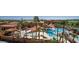 Aerial view of the community pool featuring sunshades, palm trees, and plenty of chairs at 16881 W Merrell St, Goodyear, AZ 85395