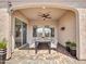 Cozy covered patio featuring a dining table, ceiling fan, and stone-paved floor for outdoor gatherings at 16881 W Merrell St, Goodyear, AZ 85395