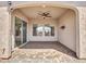 Spacious covered patio features a ceiling fan, neutral tones, and stone-paved floor for outdoor relaxation at 16881 W Merrell St, Goodyear, AZ 85395