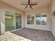 Charming covered patio featuring a ceiling fan, neutral tones, and a glass slider to the interior at 16881 W Merrell St, Goodyear, AZ 85395