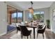 Elegant dining room with stylish chandelier, dining table, and sliding glass door to outdoor patio at 16881 W Merrell St, Goodyear, AZ 85395