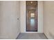 Light entryway features a glass paneled front door and hard surface flooring at 16881 W Merrell St, Goodyear, AZ 85395