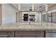 Stylish kitchen island featuring a granite countertop and stainless steel sink at 16881 W Merrell St, Goodyear, AZ 85395