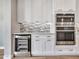 Bright kitchen with white cabinets, stainless steel appliances, and a built-in wine cooler at 16881 W Merrell St, Goodyear, AZ 85395