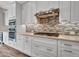 Modern kitchen features stainless steel appliances, white cabinets, and stylish backsplash at 16881 W Merrell St, Goodyear, AZ 85395