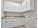 Functional laundry room with a sink, white cabinetry, countertops, and washer/dryer hookups at 16881 W Merrell St, Goodyear, AZ 85395