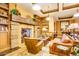 Cozy living room with a stone fireplace, built-in bookshelves, and comfortable leather furniture at 16881 W Merrell St, Goodyear, AZ 85395