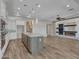Open concept living space featuring kitchen island and decorative fireplace at 16881 W Merrell St, Goodyear, AZ 85395