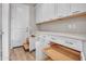 Spacious pantry with ample storage, featuring white cabinets, pull-out shelves, and a door to the garage at 16881 W Merrell St, Goodyear, AZ 85395