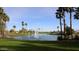 Beautiful community pond with palm trees, waterfalls, and views of the golf course at 16881 W Merrell St, Goodyear, AZ 85395