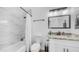 Stylish bathroom featuring a tub with marble surround and modern vanity at 1717 W Roma Ave, Phoenix, AZ 85015