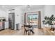Cozy dining area with glass table, next to an open kitchen and sliding glass door at 1717 W Roma Ave, Phoenix, AZ 85015