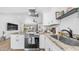 Bright kitchen boasts granite countertops, stainless steel appliances, and an open design leading into the living room at 1717 W Roma Ave, Phoenix, AZ 85015