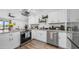 Well-equipped kitchen featuring stainless steel appliances and seamless flow to living space at 1717 W Roma Ave, Phoenix, AZ 85015