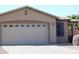 Exterior view of a two-car garage with decorative windows and a well-maintained driveway at 20282 N 104Th Ave, Peoria, AZ 85382