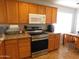 Well-equipped kitchen with stainless steel appliances and wood cabinets at 20282 N 104Th Ave, Peoria, AZ 85382