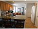 Eat-in kitchen featuring granite countertops, wood cabinetry, and modern appliances at 20282 N 104Th Ave, Peoria, AZ 85382