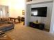 Open-concept living room featuring neutral carpet, media center, and bonus office space at 20282 N 104Th Ave, Peoria, AZ 85382