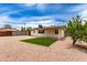 A wide view of the backyard with grass and rock landscaping at 2130 W Colter St, Phoenix, AZ 85015