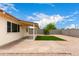 Enclosed backyard features turf, gravel, block fence, mature tree and covered patio area for outdoor entertaining at 2130 W Colter St, Phoenix, AZ 85015