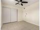 This neutral bedroom features a ceiling fan, closet and tile flooring at 2130 W Colter St, Phoenix, AZ 85015