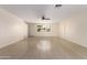 Spacious living room featuring neutral walls, tile flooring, and a ceiling fan for added comfort at 2130 W Colter St, Phoenix, AZ 85015