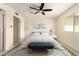 A sunlit bedroom with a ceiling fan, and ensuite bathroom offers a private retreat at 2130 W Colter St, Phoenix, AZ 85015
