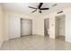 Bright main bedroom featuring neutral walls, tile floors, and a ceiling fan at 2130 W Colter St, Phoenix, AZ 85015
