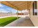 Covered patio looking out onto a gravel backyard with artificial turf and block fencing at 2130 W Colter St, Phoenix, AZ 85015