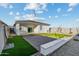 Paver patio and artificial turf creates a low-maintenance backyard, enclosed with block fencing for privacy at 24047 W Cocopah St, Buckeye, AZ 85326