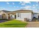 Low maintenance backyard design with artificial turf, brick pavers, desert landscaping, and patio cover at 24047 W Cocopah St, Buckeye, AZ 85326
