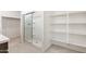 Bright bathroom featuring a glass-enclosed shower and convenient built-in shelving at 24047 W Cocopah St, Buckeye, AZ 85326