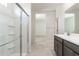 Modern bathroom featuring a glass enclosed shower and stylish tile flooring at 24047 W Cocopah St, Buckeye, AZ 85326