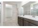 Bathroom showcasing a dual-sink vanity, large mirror, and bright lighting at 24047 W Cocopah St, Buckeye, AZ 85326