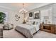Well-appointed bedroom featuring a stylish chandelier, decorative wall art, and comfortable seating area at 24047 W Cocopah St, Buckeye, AZ 85326
