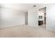 Spacious carpeted bedroom with adjoining bathroom featuring a walk-in closet at 24047 W Cocopah St, Buckeye, AZ 85326